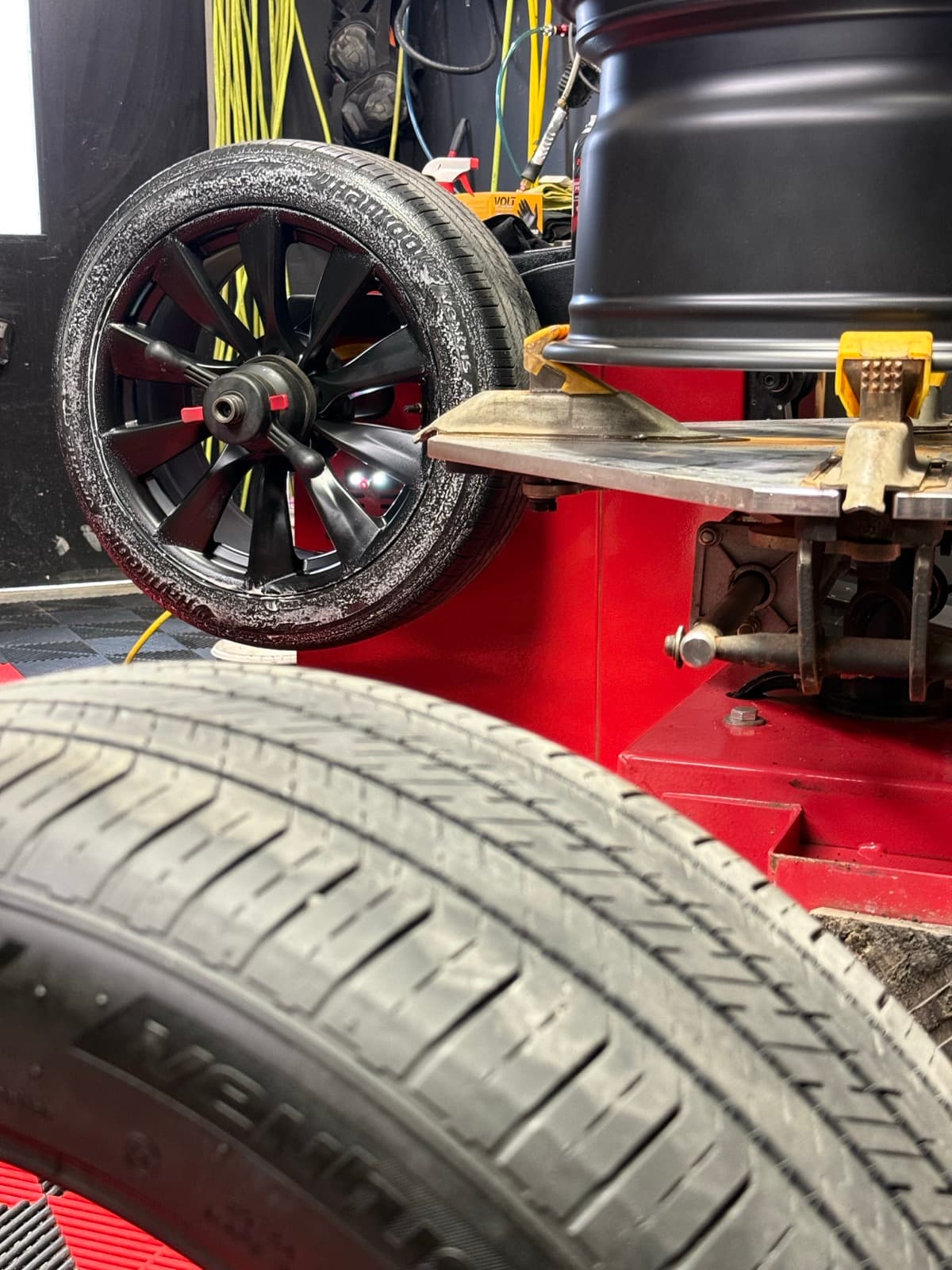 Tire mounting machine in action with a tire being mounted on a wheel